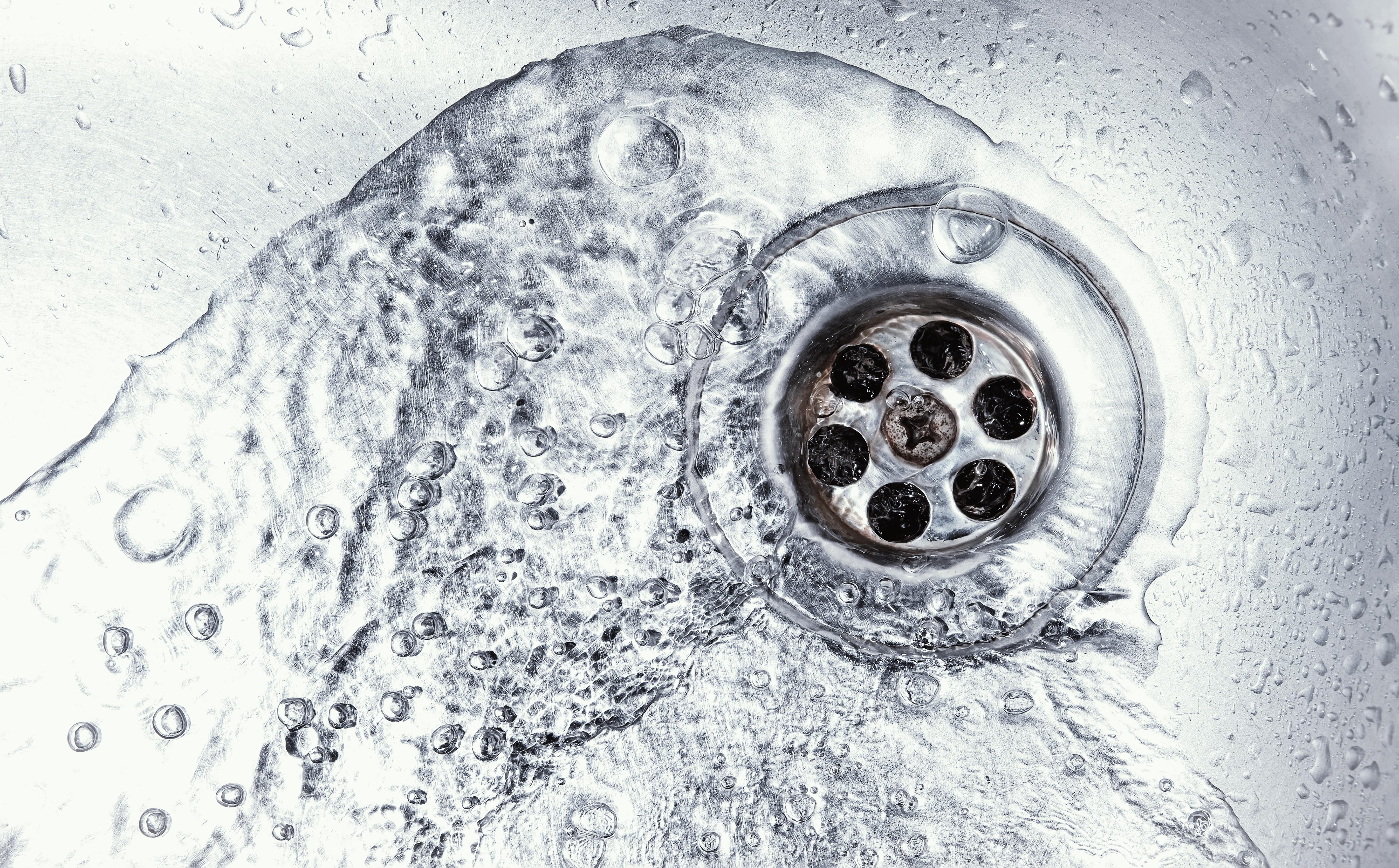 Stainless drain with water going down it